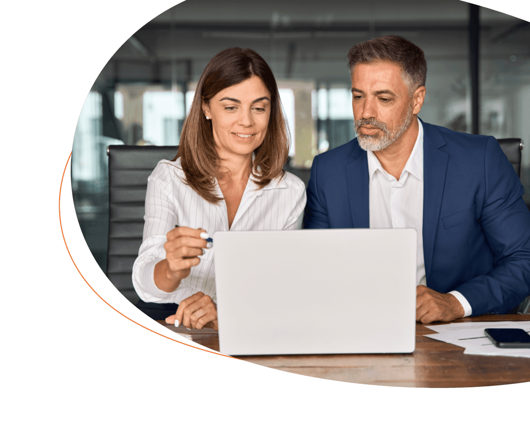 Two employees at a laptop