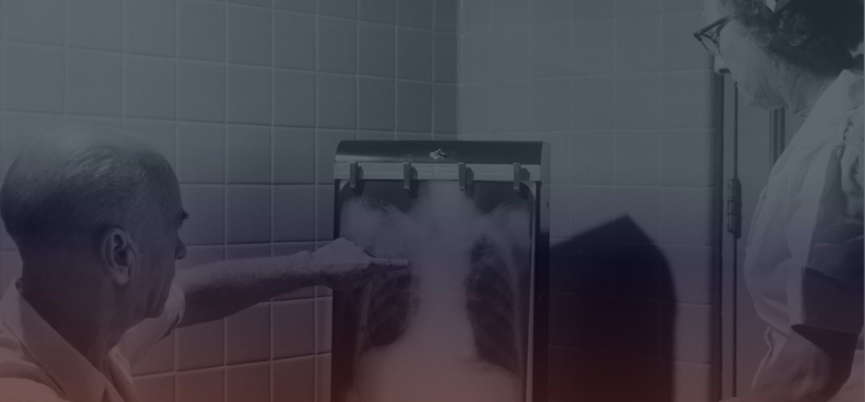 Black and white photo of doctor pointing at chest x-ray