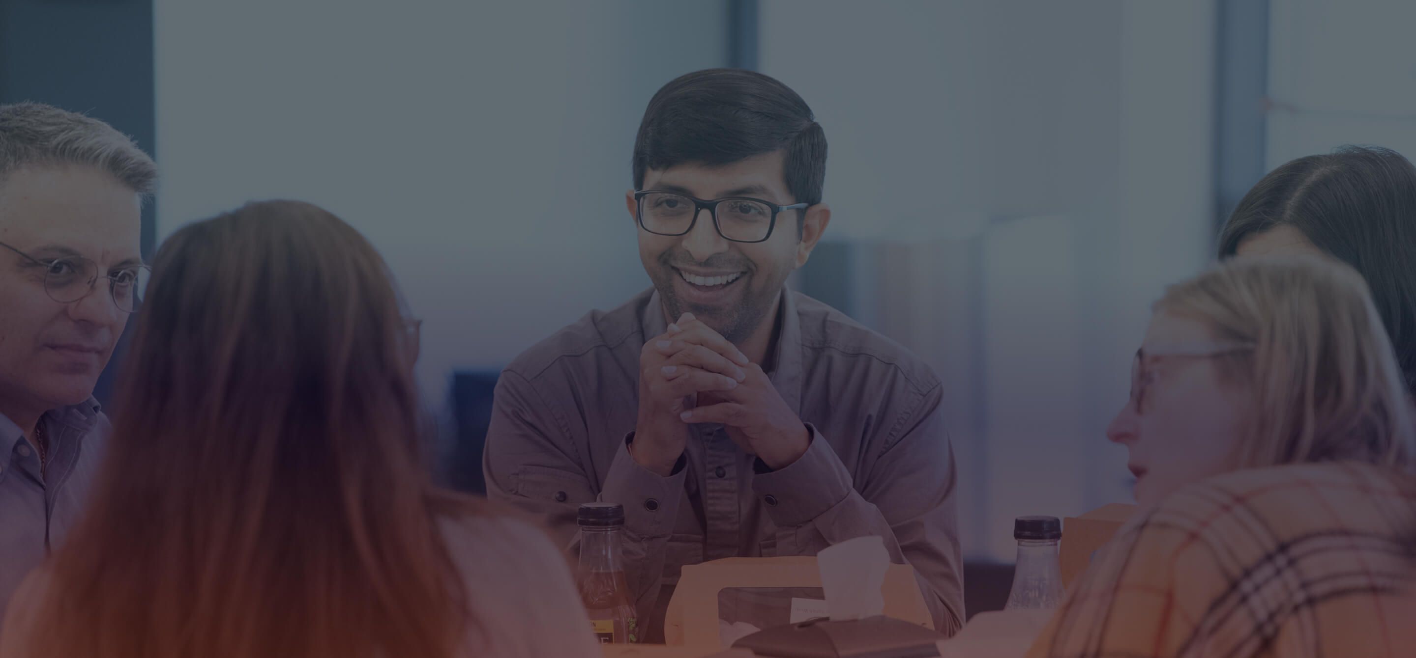 Group shot of employees at a table
