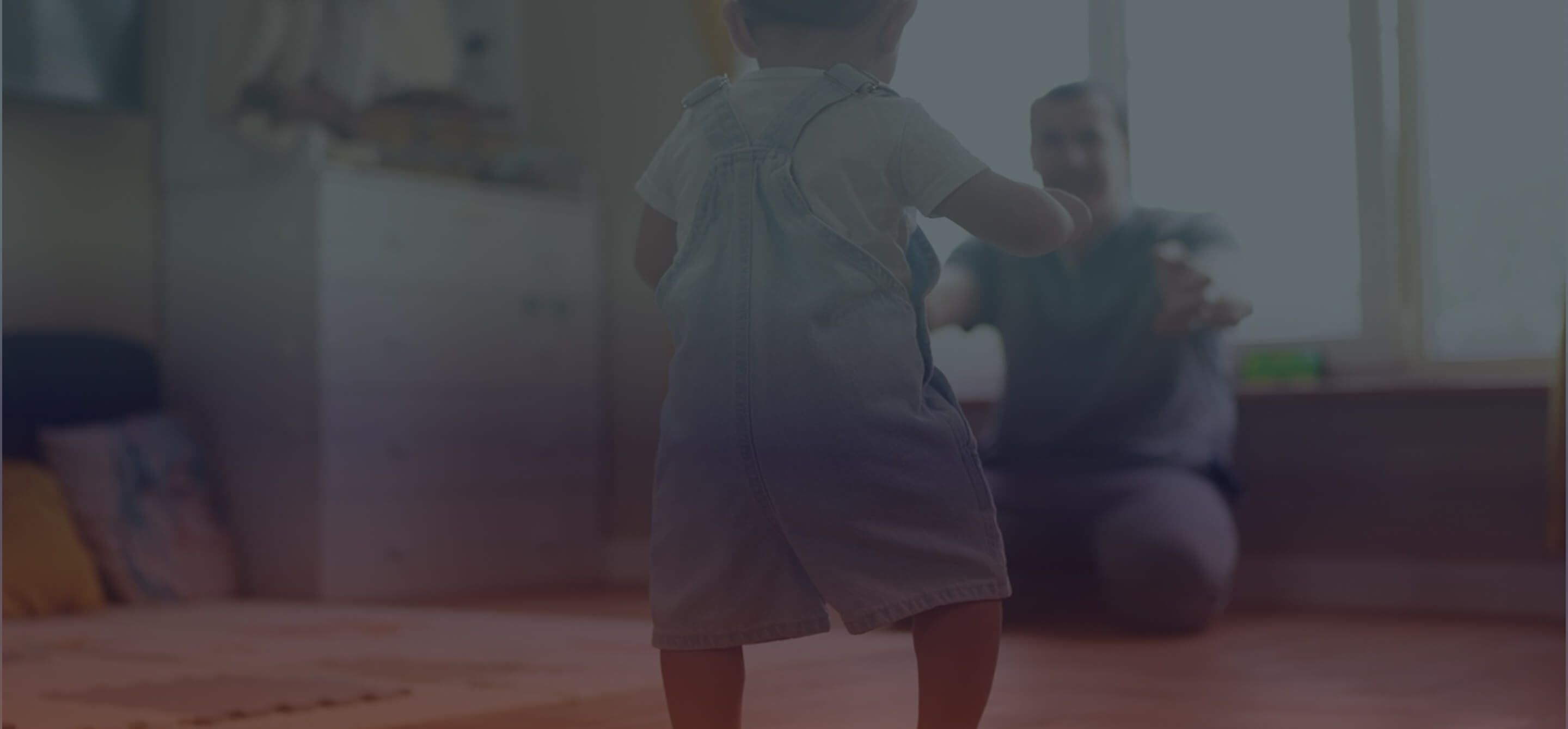 A baby takes his first steps towards his father