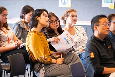 Seated employees looking to front of room