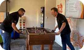 2 men playing foosball