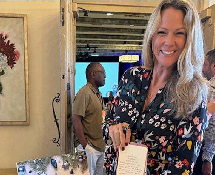 Smiling woman holding holiday card