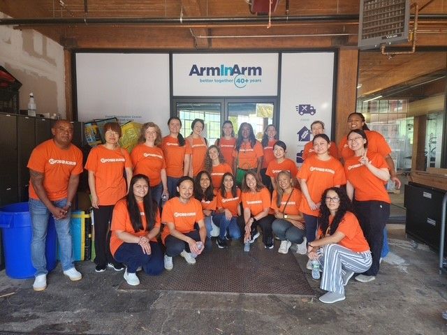 Kyowa Kirin team in orange shirts at Arm in Arm event