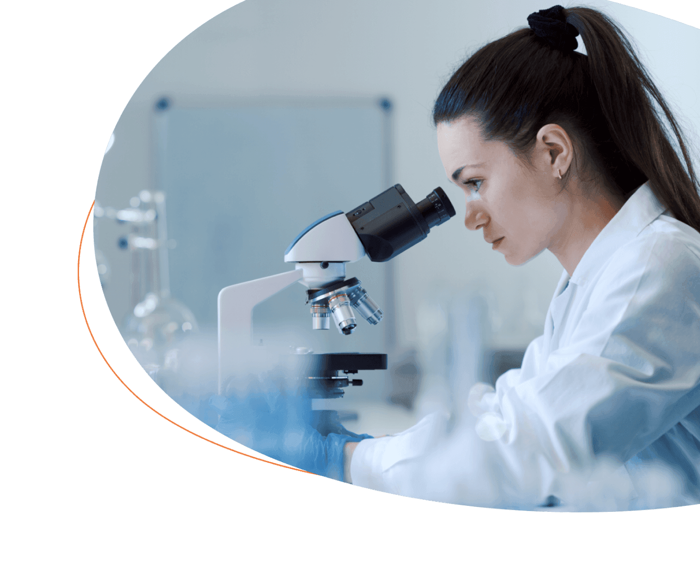 Bench scientist at microscope